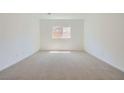 Cozy bedroom with neutral carpet, natural light, and a spacious closet at 63 Ibiza Lake Dr, Henderson, NV 89011