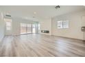 Bright, open-concept living space with wood floors, recessed lighting, and a modern fireplace at 63 Ibiza Lake Dr, Henderson, NV 89011