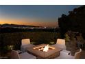 A cozy fire pit area with city views is surrounded by comfortable seating for outdoor gatherings at 641 Saint Croix St, Henderson, NV 89012
