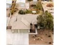 Spacious home from above with a three-car garage, large backyard, mature trees, and an outbuilding at 6908 Bienville St, Las Vegas, NV 89131