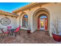 Inviting front entry with red door, patio furniture, and decorative pots at 741 Antelope Ave, Pahrump, NV 89060