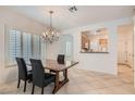 Bright dining room with chandelier and view into kitchen at 7708 Pine Warbler Way, North Las Vegas, NV 89084