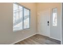 Modern entryway featuring laminate flooring and a view of an interior staircase at 8805 Jeffreys St # 1115, Las Vegas, NV 89123