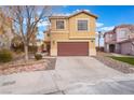 Traditional two story home with a neutral color scheme, a two car garage, and desert landscaping at 9528 Chanticleer Ct, Las Vegas, NV 89129