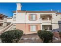 Beige two-story exterior with brown trim, balconies, windows with shutters, and well-maintained landscaping at 10233 King Henry Ave # 203, Las Vegas, NV 89144