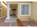 Front entrance with columns, steps, and a dark brown door at 10920 Fishers Island St, Las Vegas, NV 89141