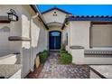 Inviting front entrance featuring a brick walkway leading to a dark blue double door at 11268 Lavandou Dr, Las Vegas, NV 89141