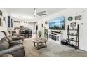 Open living room featuring modern decor, a comfortable gray sofa, and a view into the kitchen and dining area at 1134 Edel Hest Ave, North Las Vegas, NV 89081