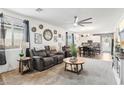 Open-concept living room with gray couches and a coffee table at 1134 Edel Hest Ave, North Las Vegas, NV 89081