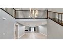 Open living area with high ceilings, a modern chandelier, and grey walls at 2204 Plaza De La Candela, Las Vegas, NV 89102