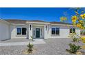 Inviting single-story home with desert landscaping, a covered entryway, and a bright green front door at 2280 S Pampa Ave, Pahrump, NV 89048