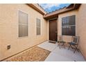 Side entrance with two chairs and small gravel area at 2595 Fountain Ave, Pahrump, NV 89048