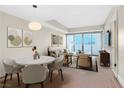Modern living room featuring a dining table, comfortable seating, and a sliding glass door to the outside at 2700 Las Vegas Blvd # 3105, Las Vegas, NV 89109