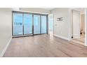 Open-concept living space with access to the balcony, featuring wood floors and a doorway to another room at 2700 Las Vegas Blvd # 3105, Las Vegas, NV 89109