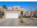 Inviting home featuring manicured landscaping, a well-kept lawn, and a spacious two-car garage at 3324 Canyon Lake Dr, Las Vegas, NV 89117