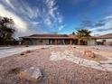 Single story home with a circular driveway and rock landscaping at 3580 W Moberly Ave, Las Vegas, NV 89139