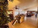 Spacious living room with a fireplace and view into the kitchen at 3580 W Moberly Ave, Las Vegas, NV 89139