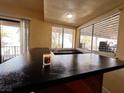 Wet bar with black countertop and window views at 3580 W Moberly Ave, Las Vegas, NV 89139