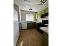 Full view of kitchen, featuring green cabinets and tile flooring at 3710 Royal Fern Cir, Las Vegas, NV 89115