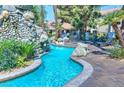 Relaxing kidney-shaped pool with a rock waterfall feature at 4200 S Valley View Blvd # 2081, Las Vegas, NV 89103