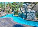 Inviting kidney shaped pool with a large rock waterfall feature at 4200 S Valley View Blvd # 2081, Las Vegas, NV 89103