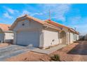 One story house with a single car garage and a terracotta roof at 424 Sarajane Lane, Las Vegas, NV 89107