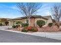 View of the home's exterior, showcasing its stone facade and landscaping at 4356 La Romita St # 2, Pahrump, NV 89061