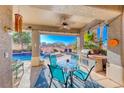 Inviting covered patio with outdoor dining area, barbecue, and pool view, perfect for entertaining guests at 471 Eagle Vista Dr, Henderson, NV 89012