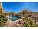 Private pool with a waterfall feature, raised spa, mature landscaping, and a serene backyard at 5635 Exotic Rosette Ave, Las Vegas, NV 89139