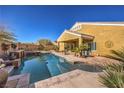 Inviting pool features a raised spa, a waterfall feature, and a covered patio perfect for outdoor living at 5635 Exotic Rosette Ave, Las Vegas, NV 89139