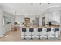 Modern kitchen with a large island, stainless steel appliances, and an adjacent dining area at 5734 San Florentine Ave, Las Vegas, NV 89141