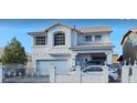 Beautiful two-story home featuring white stucco, trimmed windows and doors, a gated yard and a two car garage at 6296 Peach Orchard Rd, Las Vegas, NV 89142