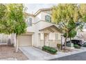 Two-story house with beige exterior, shutters, and landscaping at 7239 Proud Patriot St, Las Vegas, NV 89148