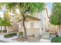 Two-story house with beige exterior, shutters, and landscaping at 7239 Proud Patriot St, Las Vegas, NV 89148