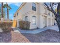 Side view of stucco home with gated entry and landscaping at 7933 Delbonita Ave, Las Vegas, NV 89147