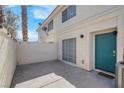 Private patio with concrete flooring and teal door access at 7933 Delbonita Ave, Las Vegas, NV 89147