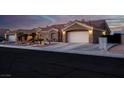 Single-story home with a two-car garage and desert landscaping at 8044 Edward Baher Ave, Las Vegas, NV 89149