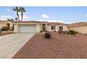 House exterior featuring a garage and rock landscaping at 8212 Bolingbrook Ave, Las Vegas, NV 89149