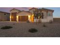 Stunning curb appeal with a large driveway and desert landscaping at 8750 Lutts St, Las Vegas, NV 89131