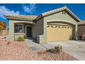 House exterior showcasing a two-car garage and front entrance at 10282 Country Flats Ln, Las Vegas, NV 89135