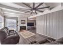 Spacious living room with hardwood floors, fireplace, and ceiling fan at 108 S Mallard St, Las Vegas, NV 89107