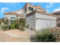 Two-story house with a three-car garage and desert landscaping at 1812 Dalton Dr, Henderson, NV 89014