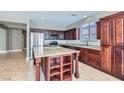 Kitchen with stainless steel appliances, granite countertops, dark wood cabinetry, and a center island perfect for entertaining at 217 Via Luna Rosa Ct, Henderson, NV 89011