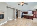 Living space open to the kitchen, fireplace, tile flooring, and neutral walls creating a warm and inviting atmosphere at 217 Via Luna Rosa Ct, Henderson, NV 89011