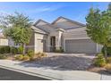 Two-story home with neutral siding, two-car garage, and nicely landscaped yard at 2364 Boretto St, Henderson, NV 89044