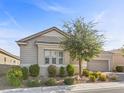 Single-story house with light-colored siding, a two-car garage, and well-manicured landscaping at 2364 Boretto St, Henderson, NV 89044