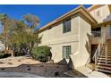 Rear exterior view of condo building showcasing stairs and landscaping at 2633 S Durango Dr # 201, Las Vegas, NV 89117