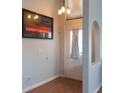 Welcoming entryway featuring tile floors, stylish lighting, and a decorative art piece at 3008 Blue Fin Cir, Las Vegas, NV 89128