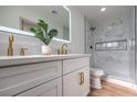 Modern bathroom with white cabinets, quartz countertops, and marble shower at 3012 Holly Hill Ave, Las Vegas, NV 89104