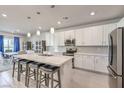 Modern kitchen featuring white cabinets, stainless steel appliances, and an island at 4390 E Cactus Canyon Dr, Pahrump, NV 89061